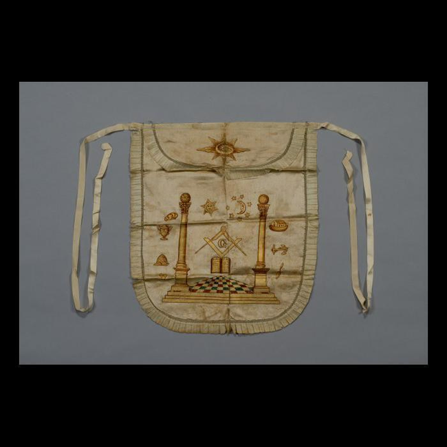 A Masonic apron with symbols such as the square and compasses, columns, the sun, and more.