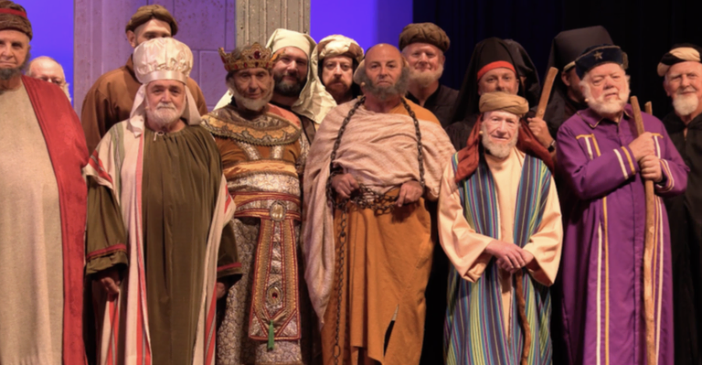 A group of Scottish Rite Brothers in the Valley of Allentown wearing colorful biblical-style costumes while posing onstage for the 17°, Knight of the East and West degree.