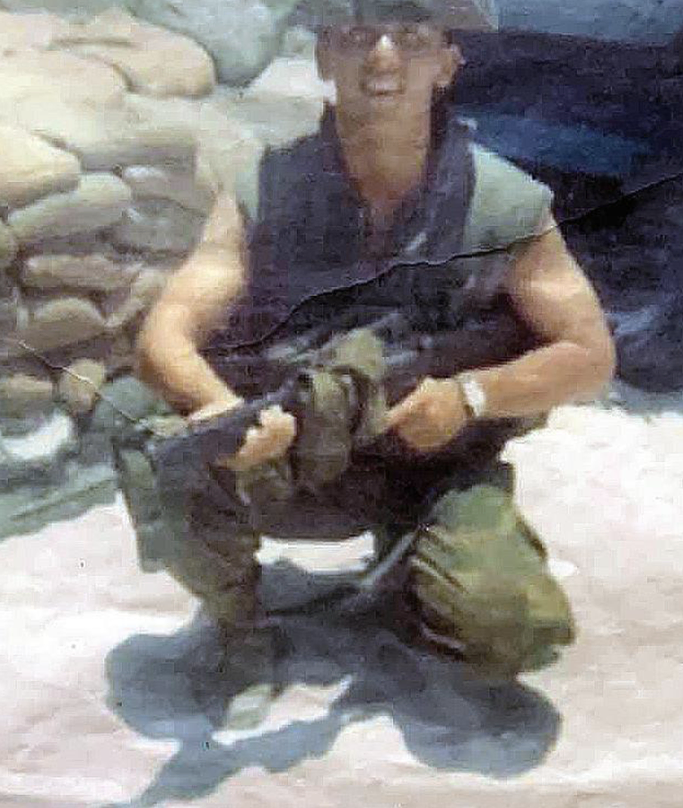 A military man in uniform holding a rifle