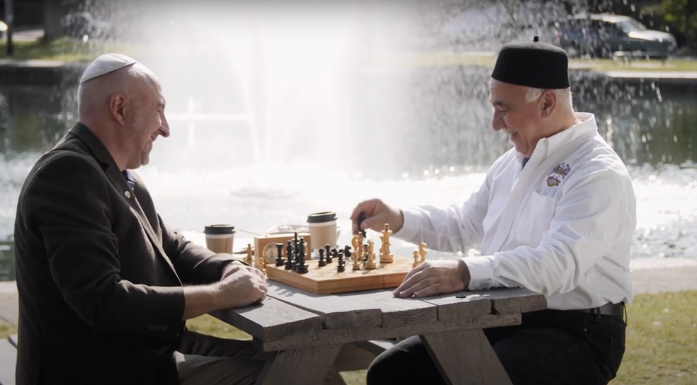 two men of differing backgrounds and religions playing chess