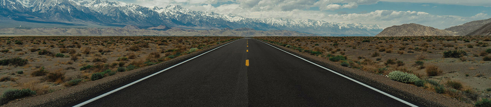 open highway with mountains in the distance