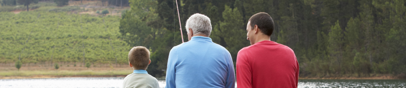 Cornerstone Society - Three generations of men sitting on a dock fishing.
