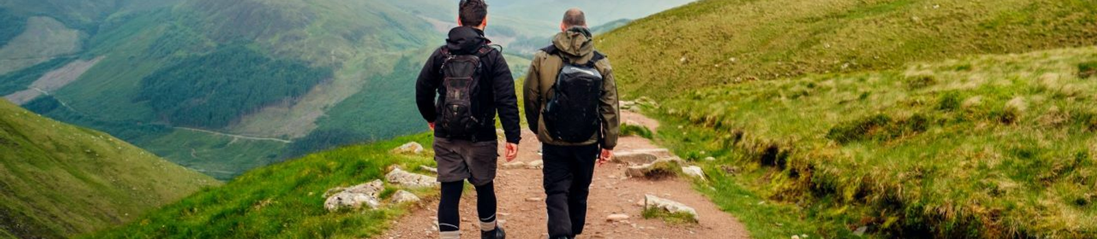 two men hiking on a path