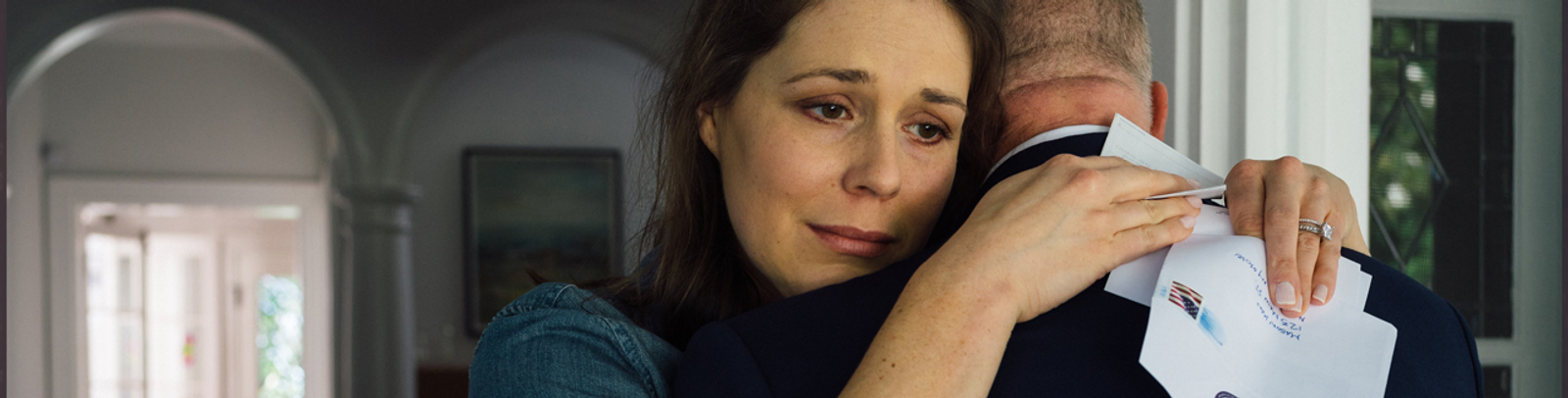 widow hugging a mason who has helped her family