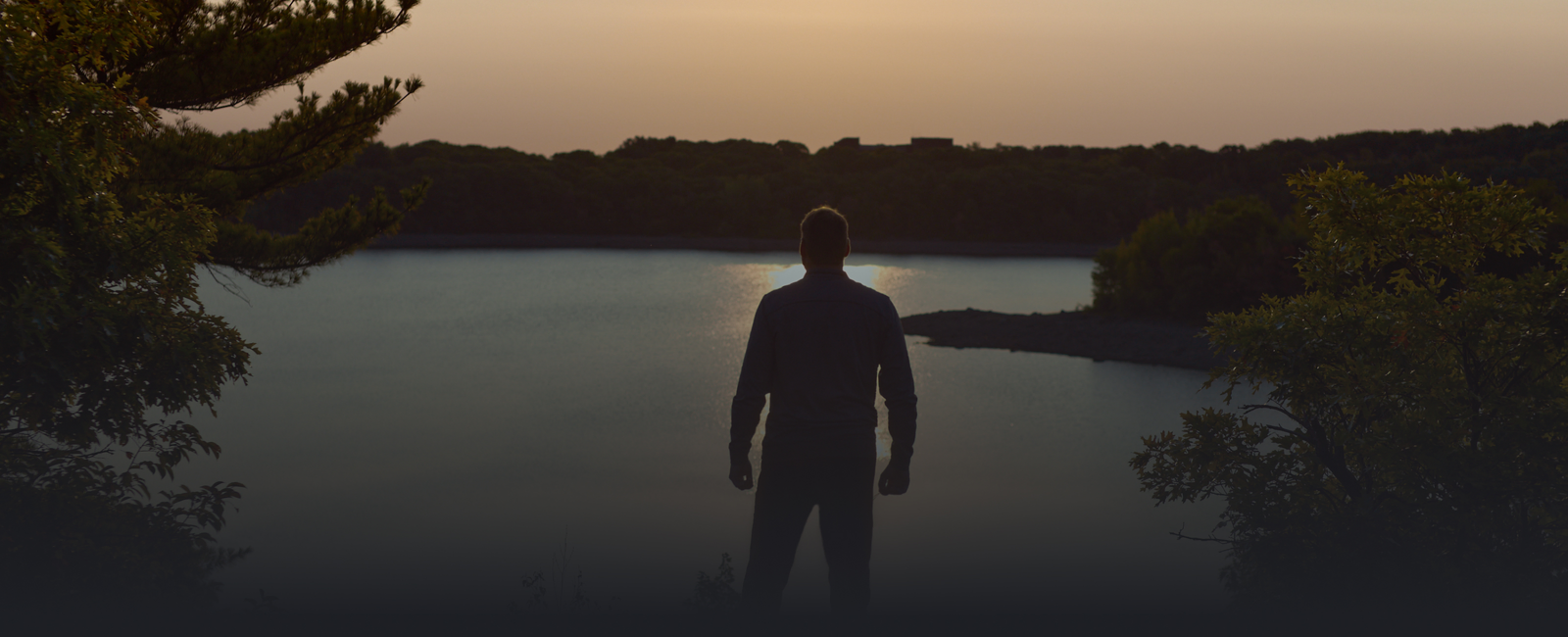 image of man looking out over a body of water