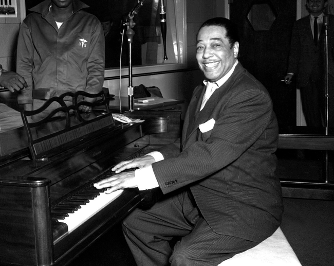 Duke poses with his piano at the KFG Radio Studio.