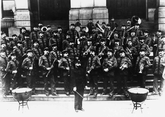 John Phillip Sousa and Sousa Band pose on steps wearing uniforms