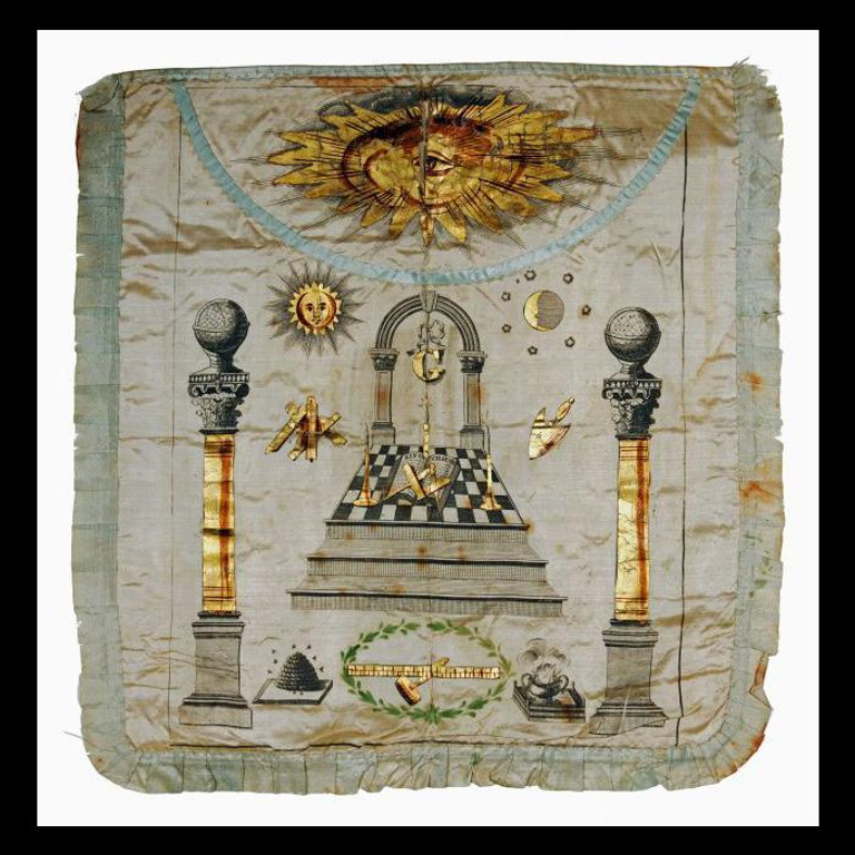 A 19th-century Masonic apron featuring the beehive symbol alongside other Freemasonry symbols, including the square and compasses, globes, and the all-seeing eye.