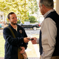 Scottish Rite mason handing another man back his wallet that he lost