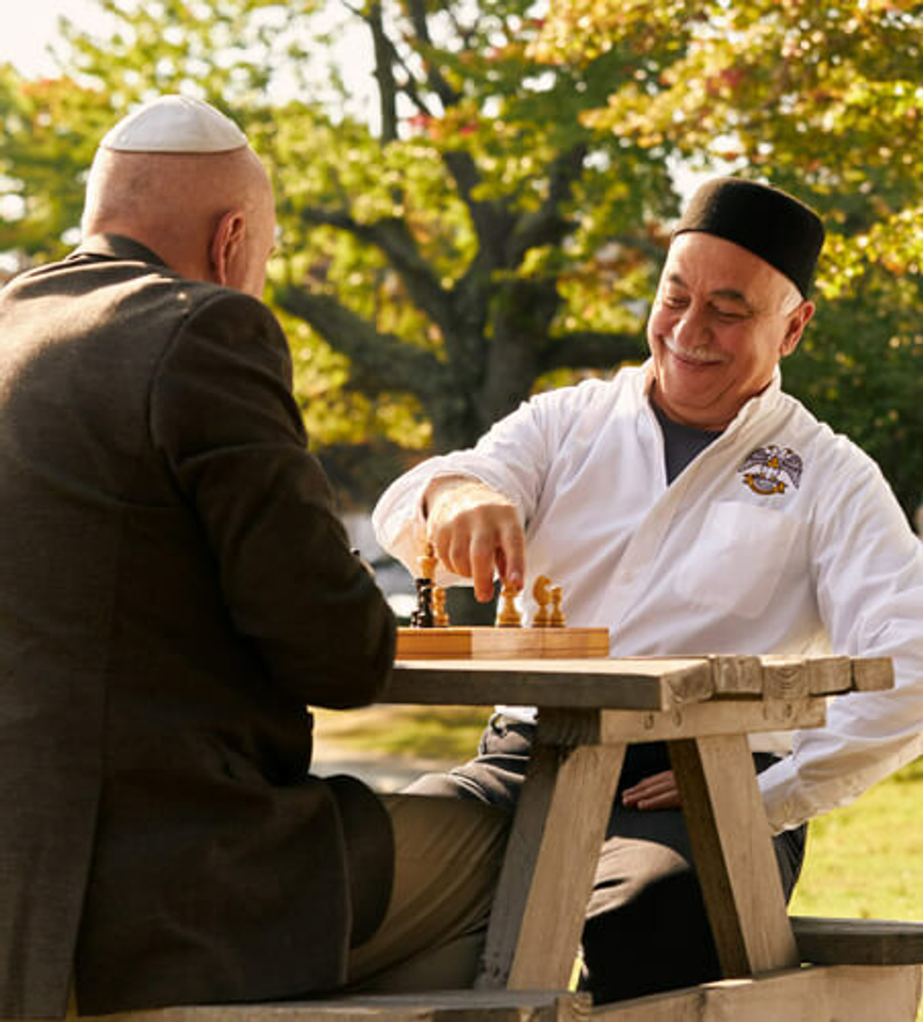 two men of differing religions playing chess