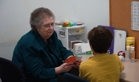 children's dyslexia center director lynda pinaud working with a child