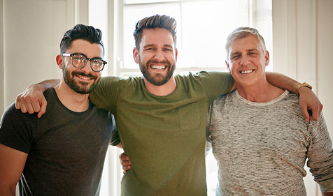 three men arm in arm smiling