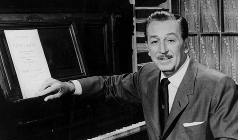 walt disney sitting next to a piano