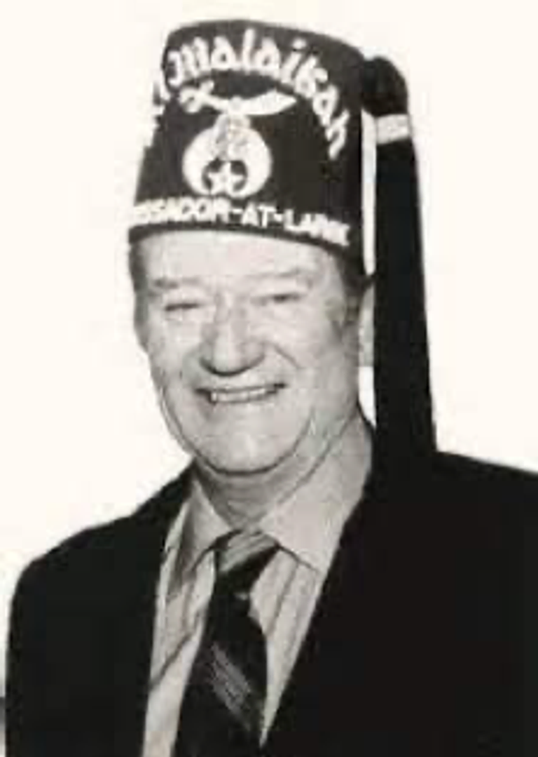 A photograph of John Wayne in his Shriner’s cap