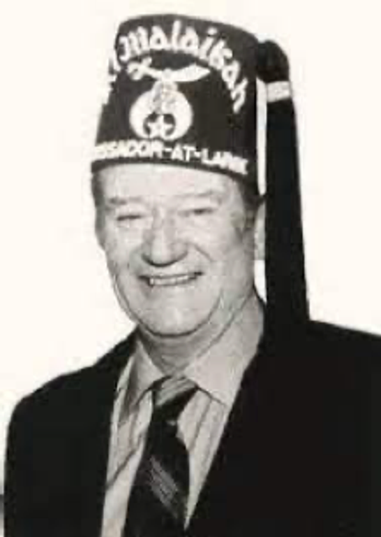 A photograph of John Wayne in his Shriner’s cap