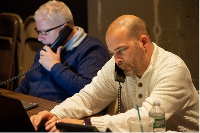 Two men collect donations over the phone during the Scottish Rite, NMJ’s Giving Tuesday event.