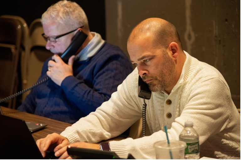 Two men collect donations over the phone during the Scottish Rite, NMJ’s Giving Tuesday event.