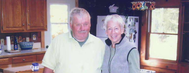 A husband and wife smiling for the camera