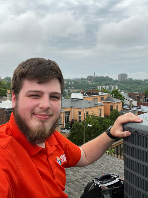 A young Scottish Rite Mason works on top of a roof