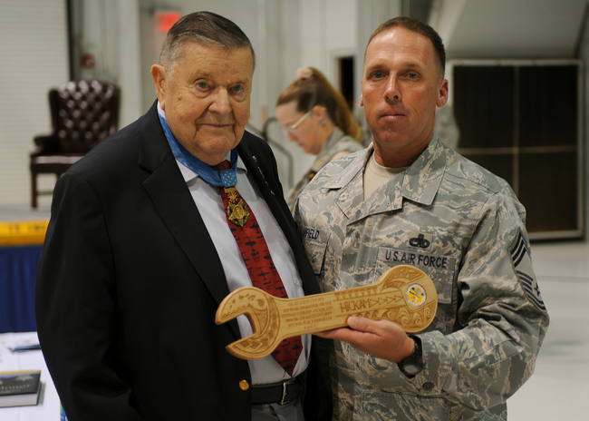 United States Air Force Colonel Joe Jackson receiving a plaque from a man in Air Force uniform