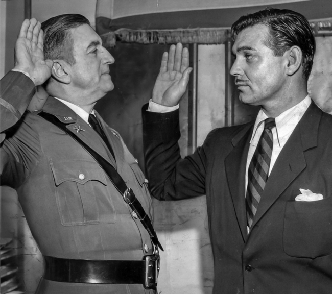 A black and white photo of Clark Gable being sworn into the military