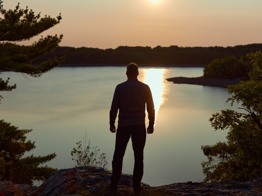 man looking out at sunrise