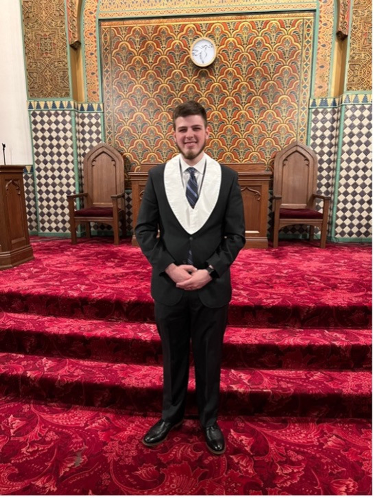A young Scottish Rite Mason standing in a Masonic lodge