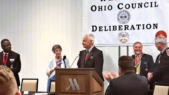 Illustrious Brother Moe at a podium with Gourgas Medal on.