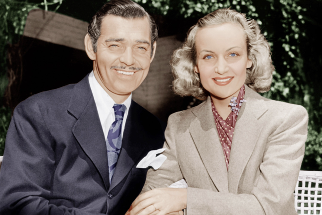 A photo of Freemason Clark Gable and his wife Carole Lombard smiling outside.