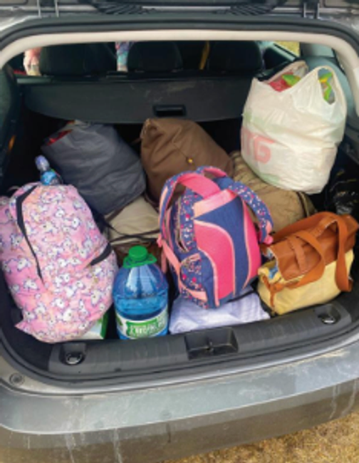 A photo showing Ukranian families’ belongings in small backpacks inside a Freemason’s car