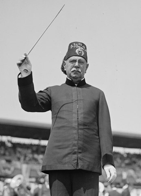 John Philip Sousa conducts his band wearing Masonic regalia including a Shriner’s fez