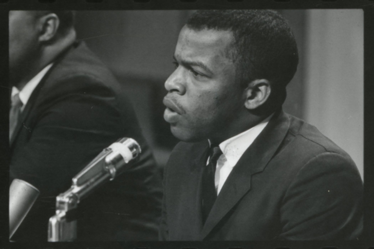 A black and white photo of John Lewis speaking at a meeting of American Society of Newspapers, 1964.