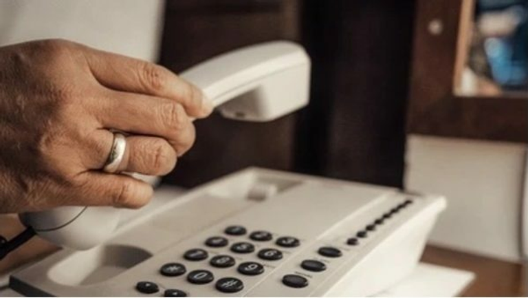 Hand on telephone