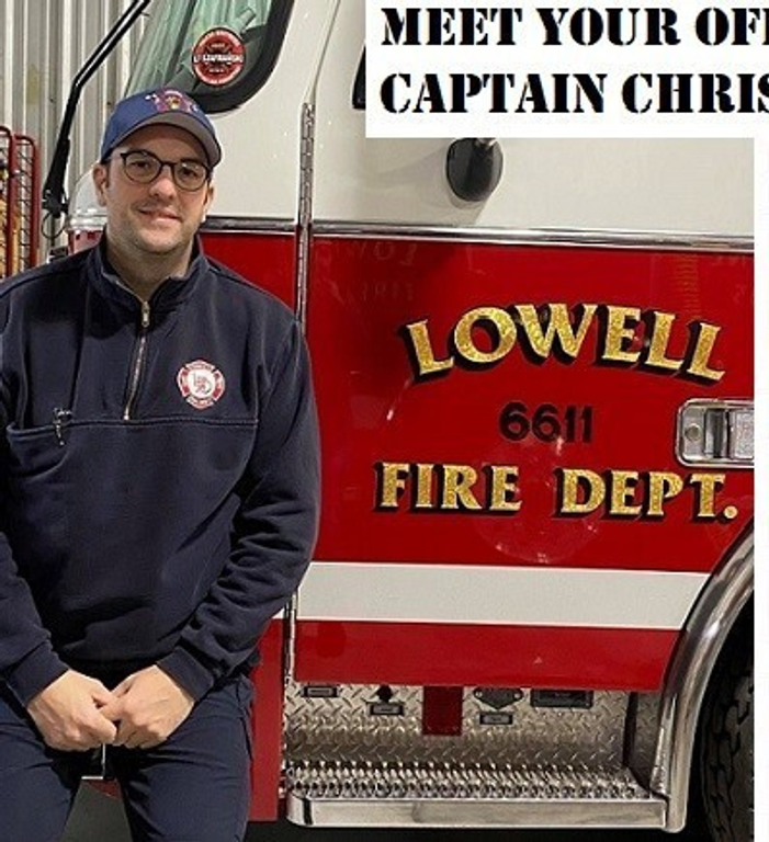 A Firefighter standing in front of a fire truck