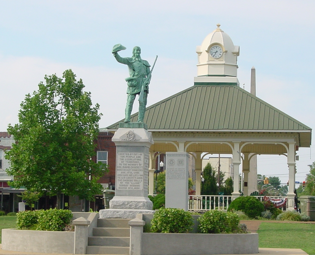 A photo of the town square in Lawrenceburg, TN with a statue of David Crockett.