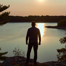 A man looking over a lake - Journey On